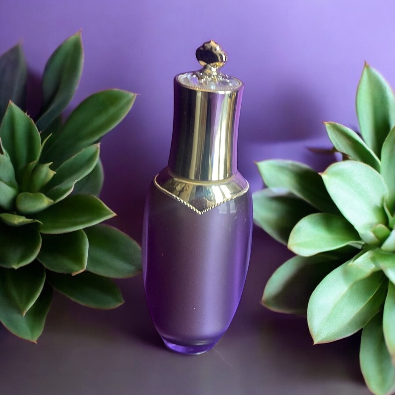 Royal Adventure Skin, Royal Glow bottle with gold cap on a purple background with green plants