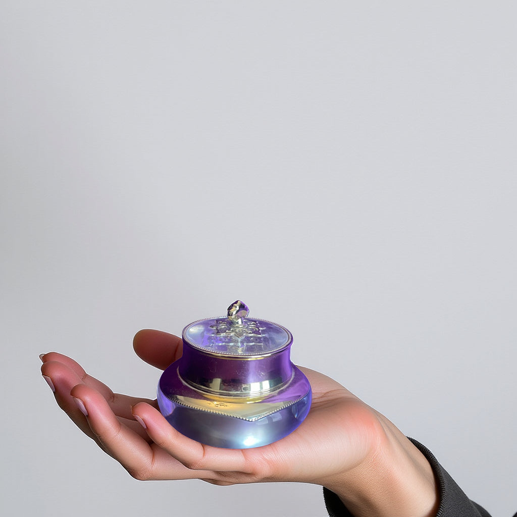 Hand holding a small purple and clear container of Royal Treatment