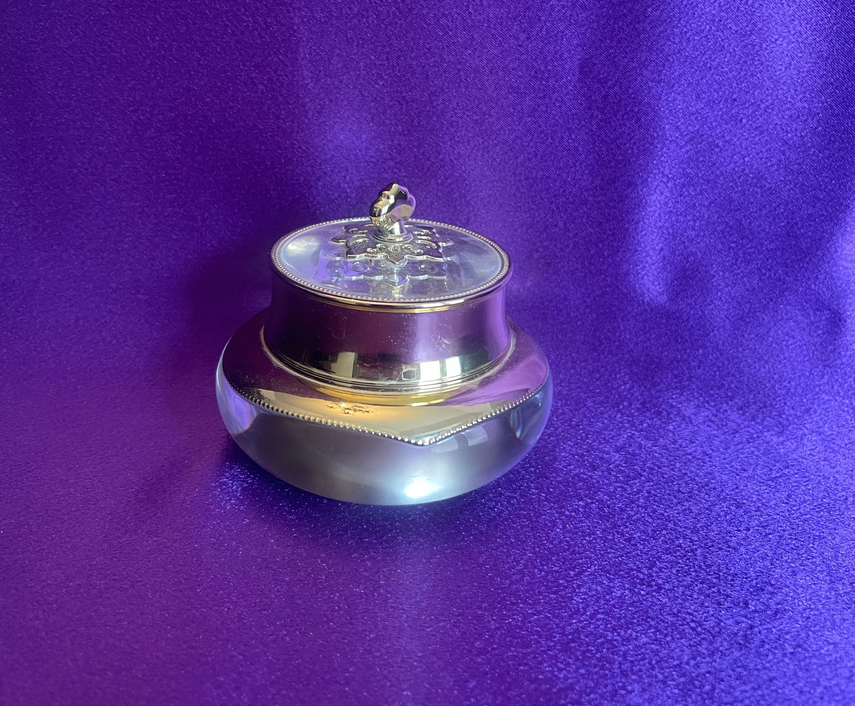 Silver and gold decorative item on a purple background